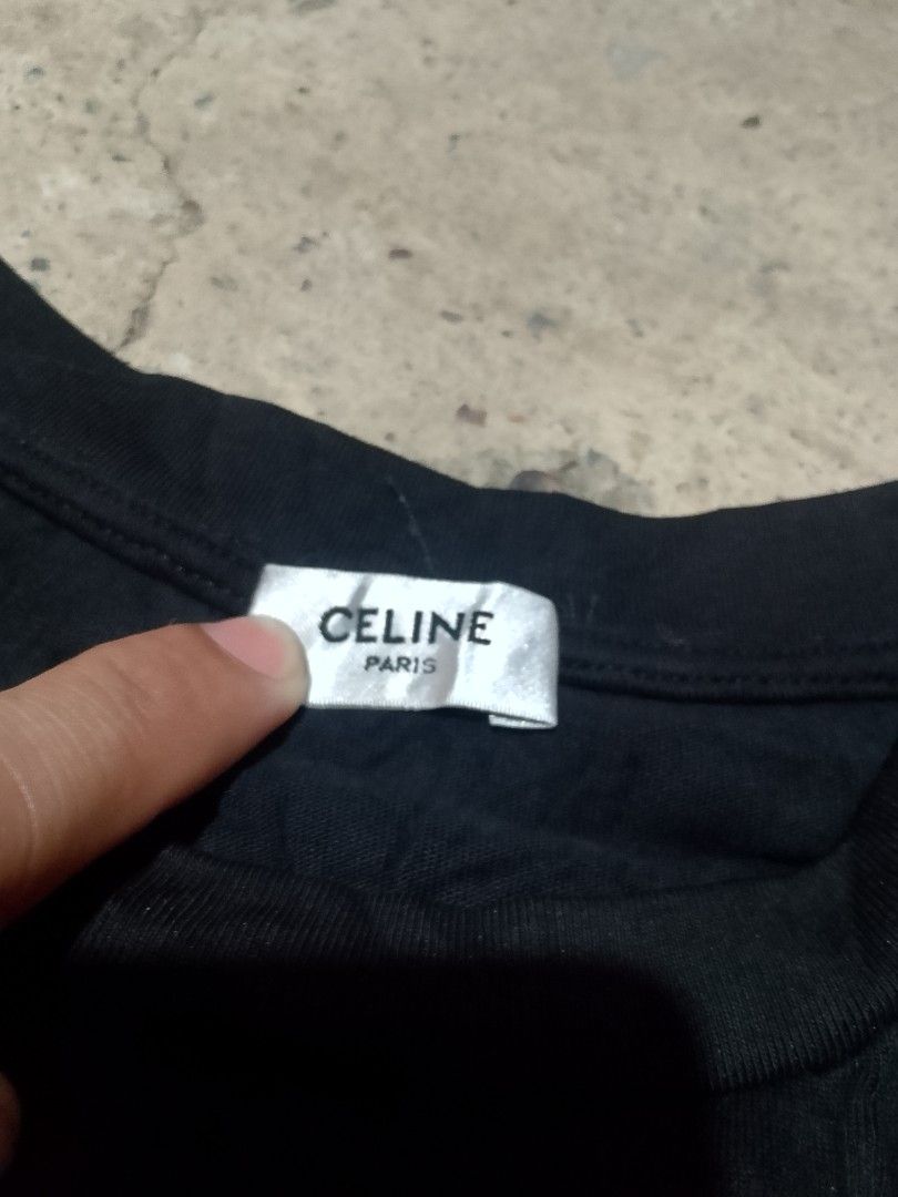 Celine Paris 16 Black T-Shirt (Category: Luxury Apparel) located in Iloilo. Submitted by janillthrifted (Listing ID 1468356107, Image 2). Description: - Brand: Celine - Color: Black with white 'CELINE 16 PARIS' chest lettering - Design: Crew neck, short sleeves - Details: Includes brand neck label and inner tag - Fit/Style: Casual everyday tee, easy to pair with jeans or shorts - Condition: Brand new with tags.