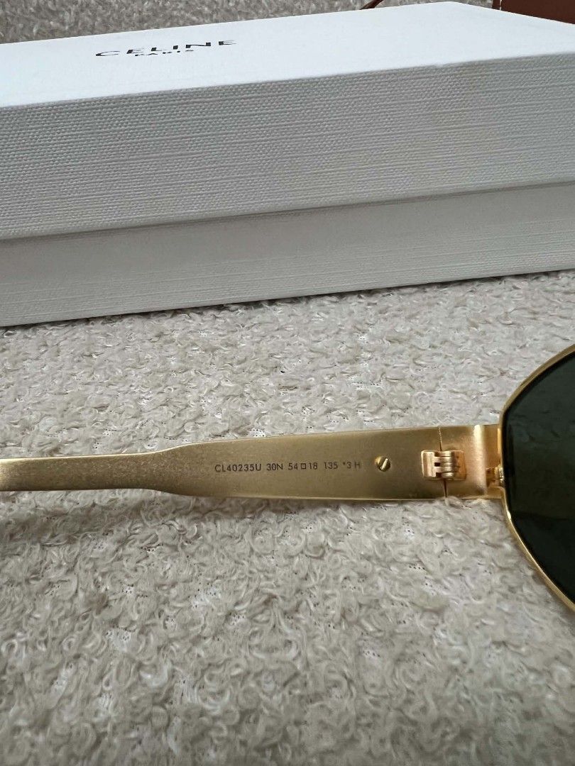 Celine Triomphe Metal Sunglasses (Category: Sunglasses & Eyewear) located in Paoay. Submitted by rvf1230 (Listing ID 1468364377, Image 3). Description: - Brand: Celine - Frame: Gold metal finish with tortoiseshell acetate temple tips - Lenses: Dark green - Details: Iconic Triomphe logo hardware on temples - Inclusions: Original tan leather case and white Celine box - Condition: Like New / Pristine.