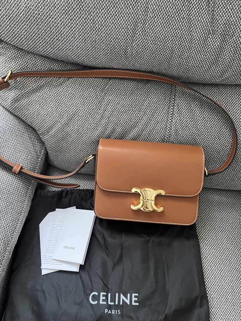 Celine Triomphe Tan Leather Shoulder Bag (Category: Luxury Bags & Wallets) located in Bulacan. Submitted by lovebyc. (Listing ID 1468332311, Image 1). Description: - Japan sourced Celine shoulder bag in smooth tan calfskin leather - Iconic gold-tone metal Triomphe front closure - Chic white contrast stitching along the edges - Adjustable shoulder strap with buckle detail - Pristine condition: zero scuffs or scratches, clean inside and out - Inclu