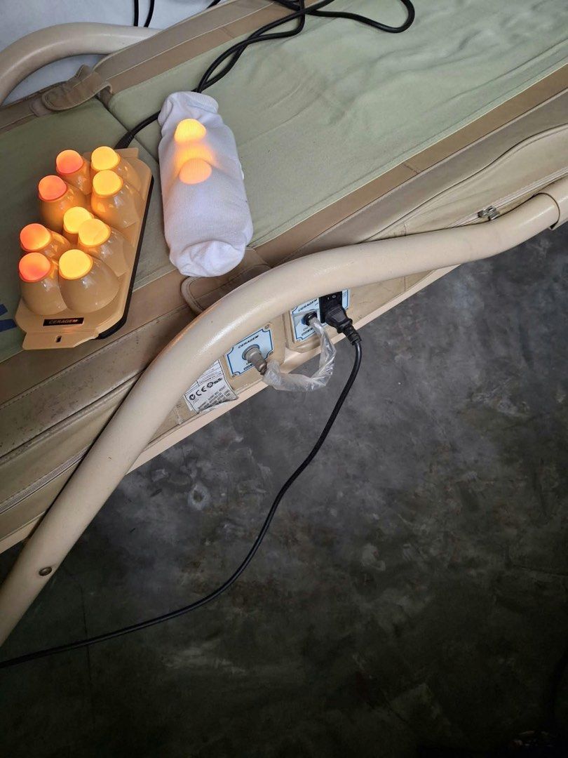 Ceragem Thermal Massage Bed with External Projectors (Category: Massage Devices) located in Manila. Submitted by kristiamac (Listing ID 1468466134, Image 3). Description: - Authentic Ceragem thermal massage bed in beige and green fabric - Includes external 9-sphere and 3-sphere light therapy projectors with fully functioning glowing bulbs - Equipped with a side-attached wired control panel and power connections - Shows normal, expected wear on th