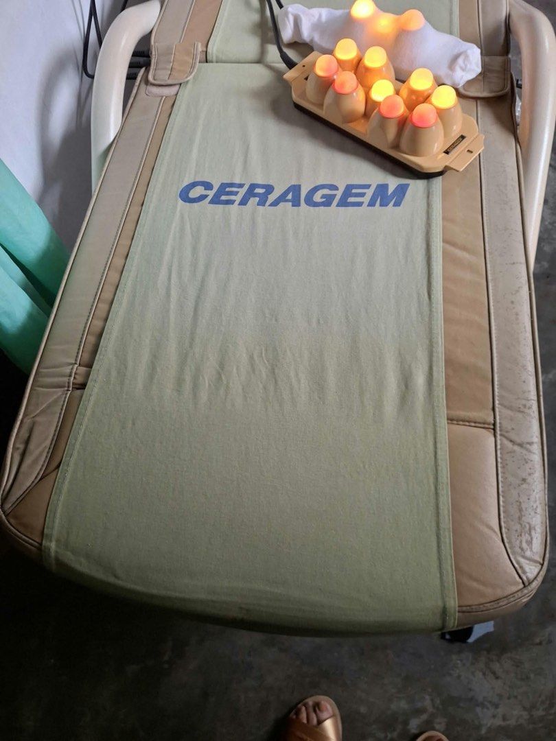 Ceragem Thermal Massage Bed with External Projectors (Category: Massage Devices) located in Manila. Submitted by kristiamac (Listing ID 1468466134, Image 1). Description: - Authentic Ceragem thermal massage bed in beige and green fabric - Includes external 9-sphere and 3-sphere light therapy projectors with fully functioning glowing bulbs - Equipped with a side-attached wired control panel and power connections - Shows normal, expected wear on th