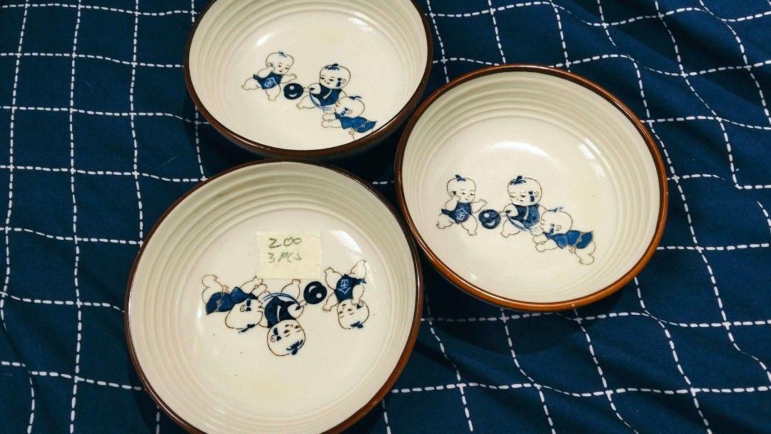 Ceramic bowls and plates tableware collection (Category: Dinnerware & Cutlery) located in Manila. Submitted by msyhue11_ (Listing ID 1468491438, Image 3). Description: - Assorted ceramic tableware and glass bowls - Available designs: Polka dot bowls, clover pattern plates, blue boy motif bowls, and iridescent fluted bowls - Sold in sets (refer to prices on sticky notes) - Perfect for serving snacks, desserts, or small side dishes - Mix and match 