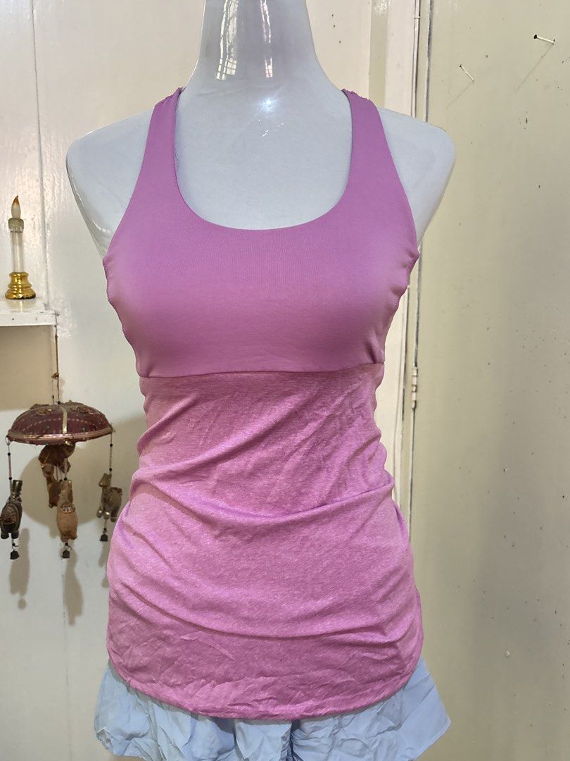 Champion C9 Pink Athletic Tank Top (Category: Sleeveless) located in Batangas. Submitted by lilirosie (Listing ID 1468345393, Image 2). Description: - Brand: Champion C9 - Style: Athletic tank top with racerback and trendy multi-strap back design - Color: Pink - Size: S / P - Features: Built-in shelf bra for extra support, soft and stretchy fabric - Details: Small C9 logo printed near the bottom hem - Condition: Excellent.