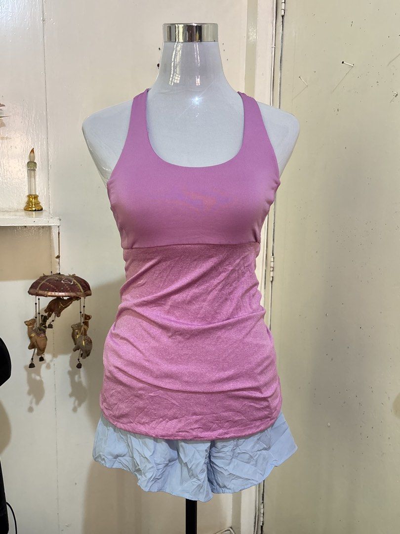 Champion C9 Pink Athletic Tank Top (Category: Sleeveless) located in Batangas. Submitted by lilirosie (Listing ID 1468345393, Image 1). Description: - Brand: Champion C9 - Style: Athletic tank top with racerback and trendy multi-strap back design - Color: Pink - Size: S / P - Features: Built-in shelf bra for extra support, soft and stretchy fabric - Details: Small C9 logo printed near the bottom hem - Condition: Excellent.