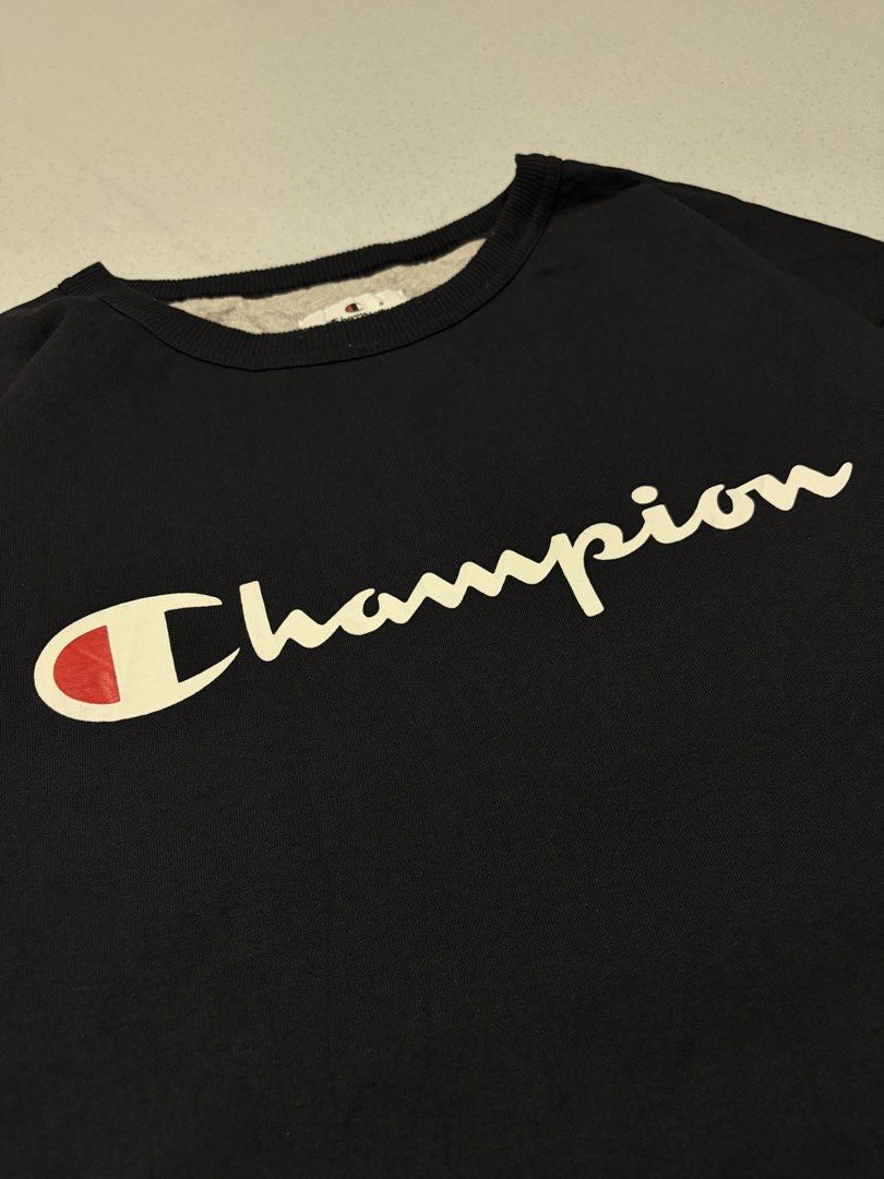 Champion Dark Navy Script Logo Crewneck Sweatshirt (Category: Coats, Jackets and Outerwear) located in Cainta. Submitted by rizalthriftstuff (Listing ID 1468368756, Image 3). Description: Champ Script Navy Blue Dimes Size: 3XL Tall Width: 28 Length: 34 Color Rate: 9 Condition: 8 Issue: Oil Stain Mine - ₱400 - Brand/Style: Champion crewneck sweatshirt - Color: Dark navy with large cream script logo - Details: Classic embroidered C logo patch on le