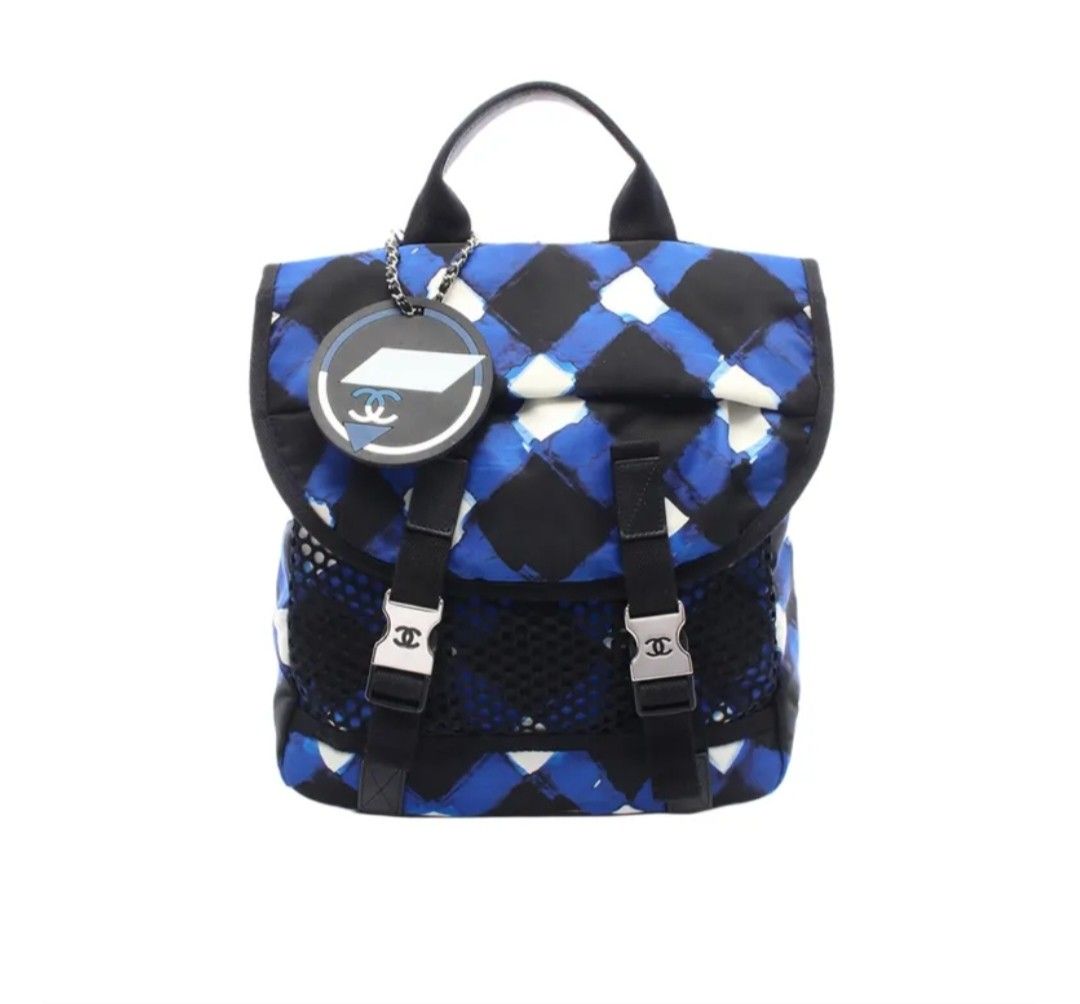 Chanel Graphic Print Nylon Backpack Blue Black (Category: Backpacks) located in Manila. Submitted by cutestuffbyasiana (Listing ID 1468492008, Image 1). Description: - not sure if Authentic Chanel backpack but the quality is good - Classic quilted diamond pattern all over with a trendy mesh front pocket - Dual straps equipped with metal buckles featuring the iconic CC logo - Includes a matching round luggage tag charm attached to the top handle -