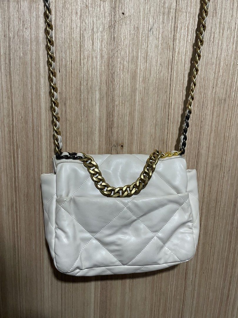 Chanel White Quilted Leather Shoulder Bag (Category: Luxury Bags & Wallets) located in Cebu City. Submitted by lucky.finds.ph (Listing ID 1468345363, Image 2). Description: - Authentic Chanel quilted leather bag in timeless white - Mixed gold and ruthenium metal hardware chain strap - Iconic front flap with secure CC turn-lock closure - Luxurious burgundy interior lining - Convenient exterior magnetic back pocket - Perfect, stylish everyday compa