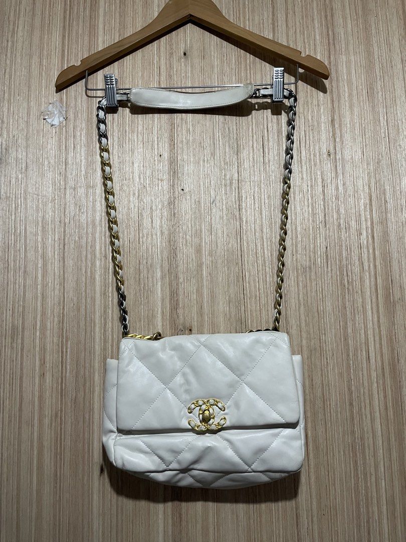Chanel White Quilted Leather Shoulder Bag (Category: Luxury Bags & Wallets) located in Cebu City. Submitted by lucky.finds.ph (Listing ID 1468345363, Image 1). Description: - Authentic Chanel quilted leather bag in timeless white - Mixed gold and ruthenium metal hardware chain strap - Iconic front flap with secure CC turn-lock closure - Luxurious burgundy interior lining - Convenient exterior magnetic back pocket - Perfect, stylish everyday compa