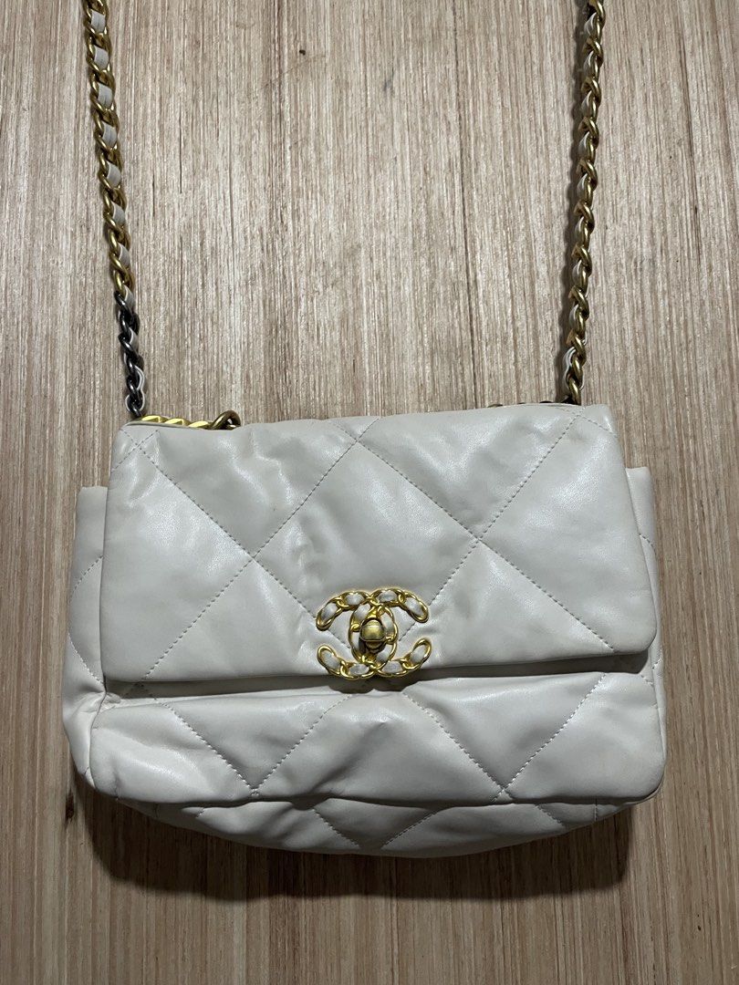 Chanel White Quilted Leather Shoulder Bag (Category: Luxury Bags & Wallets) located in Cebu City. Submitted by lucky.finds.ph (Listing ID 1468345363, Image 3). Description: - Authentic Chanel quilted leather bag in timeless white - Mixed gold and ruthenium metal hardware chain strap - Iconic front flap with secure CC turn-lock closure - Luxurious burgundy interior lining - Convenient exterior magnetic back pocket - Perfect, stylish everyday compa