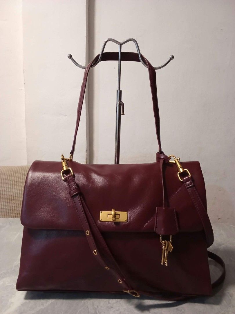 Charles & Keith Burgundy Shoulder Bag (Category: Shoulder Bags) located in Manila. Submitted by cosmiccloud-9236 (Listing ID 1468478498, Image 1). Description: - Brand: Charles & Keith - Color: Rich burgundy with premium gold-tone hardware - Closure: Secure front flap with twist-lock mechanism - Straps: Comes with fixed shoulder straps and a detachable long crossbody strap - Pockets: Convenient exterior back slip pocket with metallic logo plate -