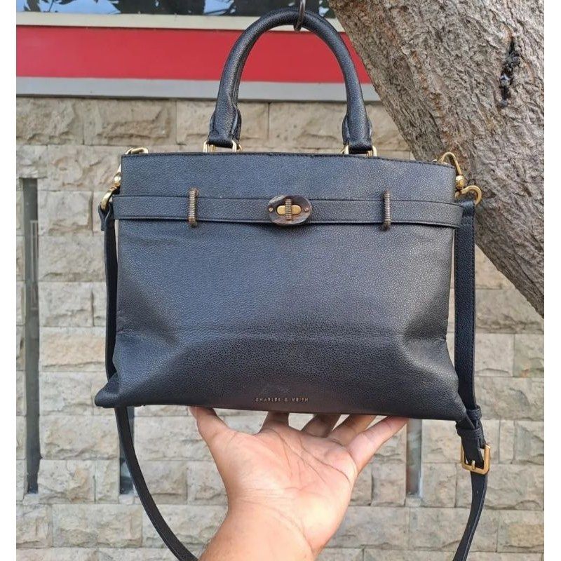 Charles & Keith Turn-Lock Tote Bag (Category: Shoulder Bags) located in Mandaluyong City. Submitted by jillylilly (Listing ID 1468340463, Image 1). Description: Best for petite women. Small enough to not look bulky. Big enough to fit a tablet. Perfect for night outs. Made with sturdy black leather. Structured enough to stand on its own. .
