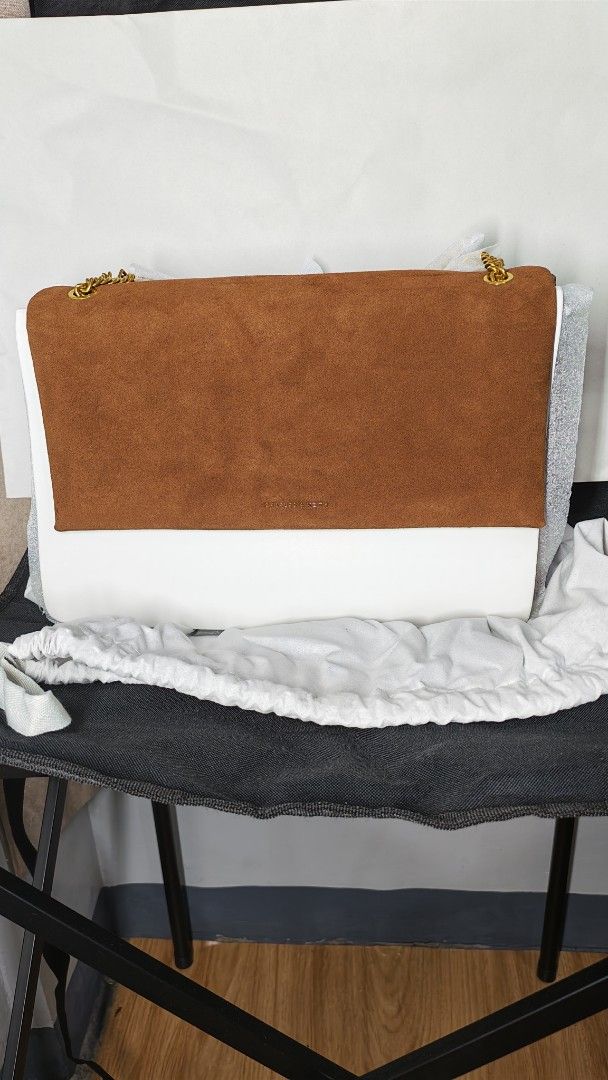 Charles & Keith Two-Tone Suede Shoulder Bag (Category: Shoulder Bags) located in Manila. Submitted by chubbychic553 (Listing ID 1468295751, Image 1). Description: - Stylish brown suede flap with a clean white base - Elegant gold-tone chain strap and hardware - Secure zip top closure under the main flap - Fully lined brown fabric interior - Includes back slip pocket - Comes with original dust bag Php 5000.