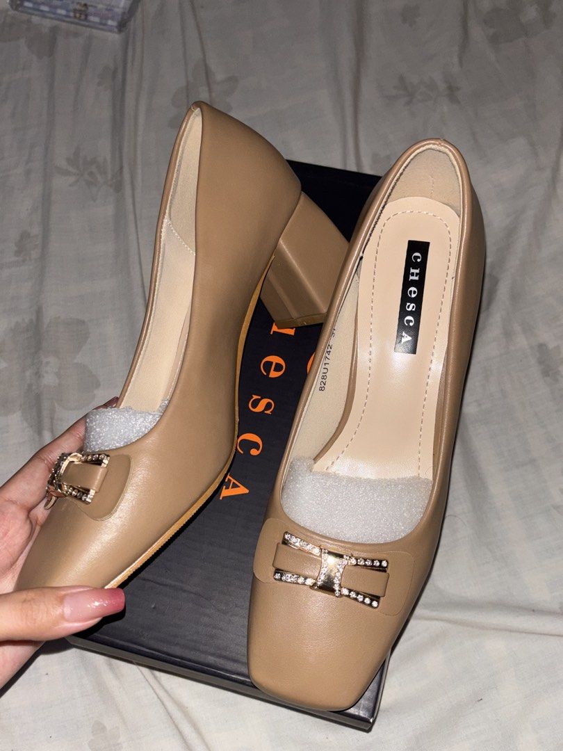 Chesca Block Heel Pumps Size 37 Nude (Category: Heels) located in Manila. Submitted by ernndlcrzl72179 (Listing ID 1468351280, Image 2). Description: Chesca block heel pumps in nude beige. Size 37. Square toe design with rhinestone embellished bow detail on the front. Chunky block heel for comfortable walking. Original shoe box included inside. Packing foam still stuffed inside the shoes. Clean insoles and pristine outer material. Wore it once, I