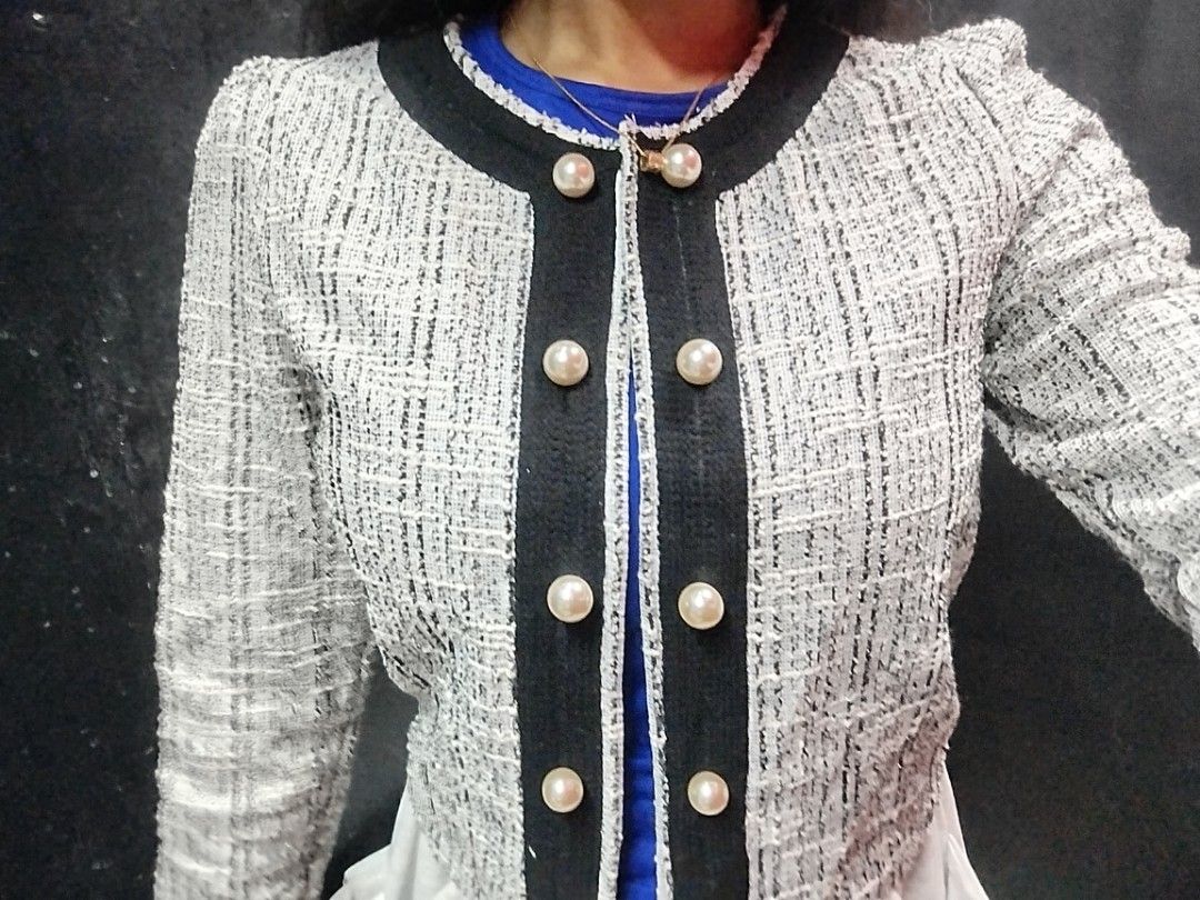 Chic Tweed Jacket with Pearl Buttons (Category: Coats, Jackets and Outerwear) located in Quezon City. Submitted by cuteitemsonlyyy (Listing ID 1468417704, Image 3). Description: - Black and white tweed fabric with subtle silver threading - Classic round neckline with black fabric trim - Front button closure featuring elegant faux pearl and gold-rimmed buttons - Long sleeves with gentle gathering at the shoulders - Stylish cropped length, perfect 