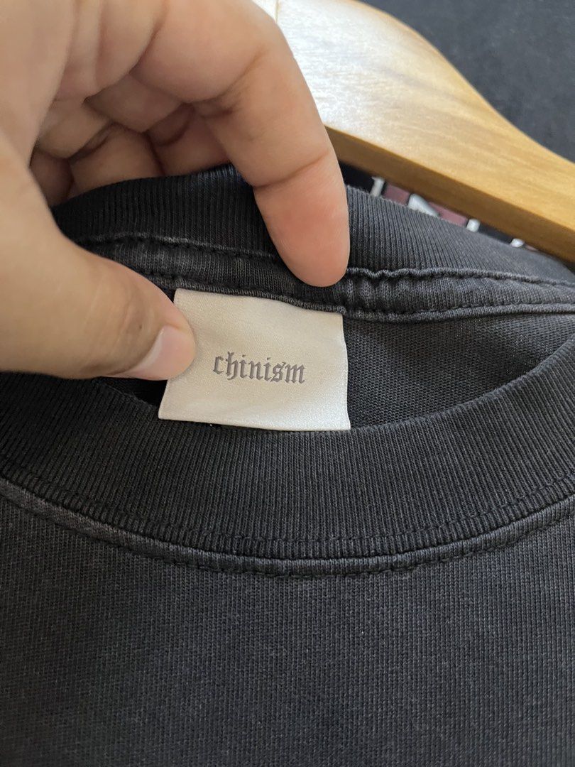 Chinism Black Gothic Ch Logo Tee (Category: Tshirts & Polo Shirts ) located in Manila. Submitted by thriftniking (Listing ID 1468466048, Image 3). Description: Chinism Dimes: 24x29 Excellent condition Color Color rate 9/10 Mop: gcash/maribank Mop: jnt/lalamoved Black short sleeve t-shirt from chinism. Large white gothic ch logo print on the chest. Classic crew neckline and straight hem. 100 percent cotton fabric with a washed vintage look. Interi