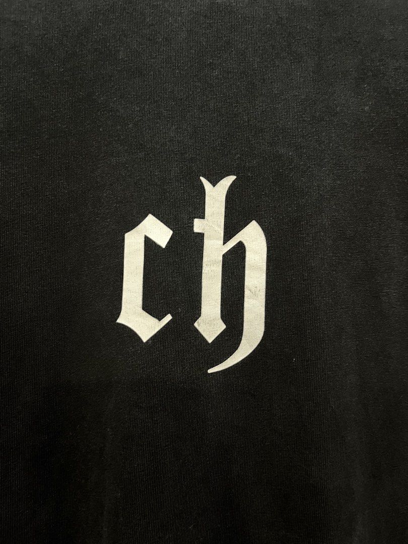 Chinism Black Gothic Ch Logo Tee (Category: Tshirts & Polo Shirts ) located in Manila. Submitted by thriftniking (Listing ID 1468466048, Image 2). Description: Chinism Dimes: 24x29 Excellent condition Color Color rate 9/10 Mop: gcash/maribank Mop: jnt/lalamoved Black short sleeve t-shirt from chinism. Large white gothic ch logo print on the chest. Classic crew neckline and straight hem. 100 percent cotton fabric with a washed vintage look. Interi