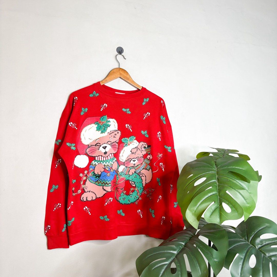 Christmas (Nutcracker) | Sweater. (Category: Coats, Jackets and Outerwear) located in Manila. Submitted by bypiecesandstories (Listing ID 1468324005, Image 1). Description: Christmas (Nutcracker) | Sweater. 699 PHP 🧡 Good Condition Can Fit — Medium to X Large Dimensions — W 26" L 27" A vibrant red Christmas sweater covered in fun, colorful holiday graphics. Perfect for those who love a festive look and want a standout piece for the Christmas sea