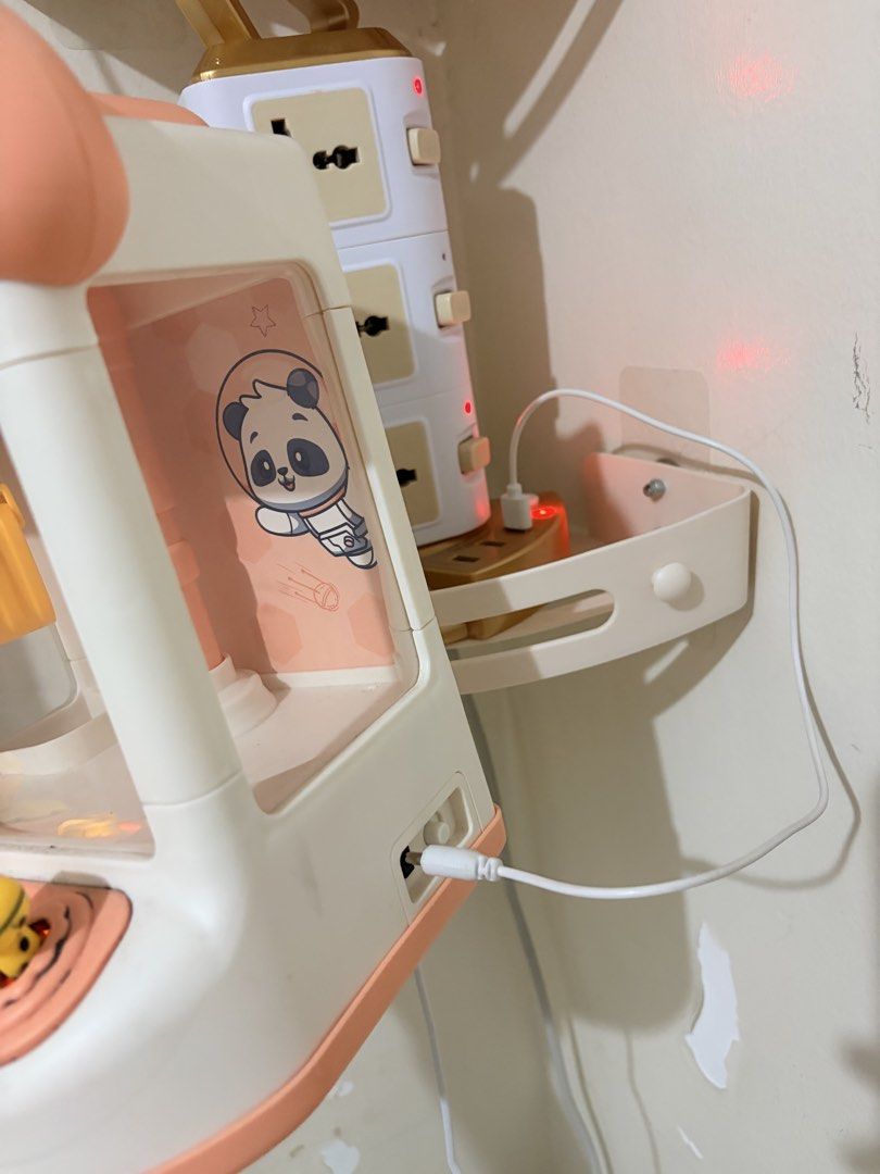 Claw Machine (Category: Kids Toys) located in Makati City. Submitted by makatigirlpreloved (Listing ID 1468377995, Image 3). Description: - Color: Pink and white with an adorable panda astronaut graphic inside - Controls: Fun yellow joystick and interactive buttons - Power: Convenient USB power cable included (plugs into side port) - Perfect for: Hours of entertainment grabbing small toys and prizes - Condition: Brand new and ready for playtime f