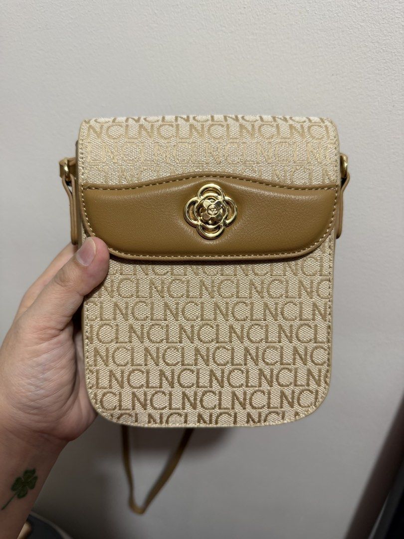 CLN Kathalia Monogram Sling Bag (Category: Cross-body Bags) located in Quezon City. Submitted by czarijay06 (Listing ID 1468355879, Image 2). Description: - Brand: CLN - Style: Kathalia sling bag - Color: Beige and tan with chic woven monogram texture and synthetic leather trim - Hardware: Elegant gold-tone metal clasp closure on the front flap - Interior: Clean lining with one zippered pocket and one slip pocket - Strap: Adjustable shoulder stra