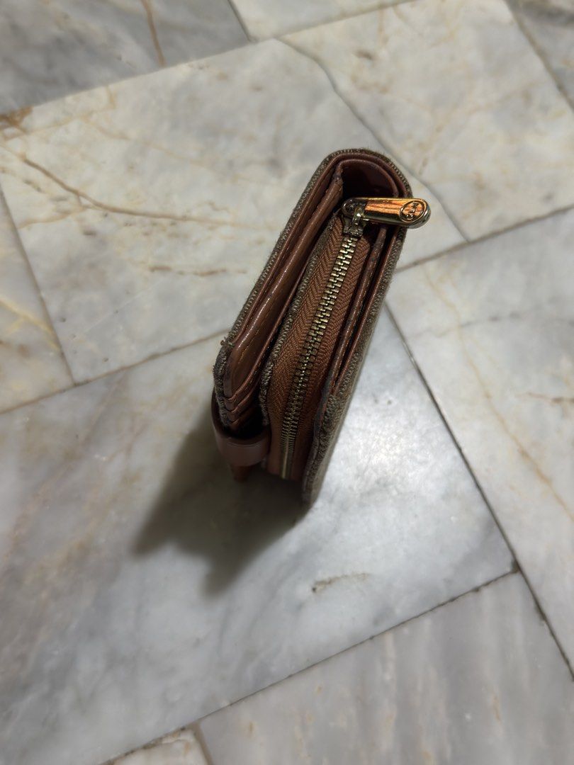 CLN Monogram Brown Short Wallet (Category: Luxury Bags & Wallets) located in Pozorrubio. Submitted by christajoi79316 (Listing ID 1468343576, Image 3). Description: - Brand: CLN - Design: Brown monogram pattern with faux leather trim - Closure: Secure snap button - Storage: Multiple card slots and a zipped coin compartment - Extra: Adorable floral metal charm - Size: Compact, fits easily in small bags - Condition: Clean interior with minimal wear