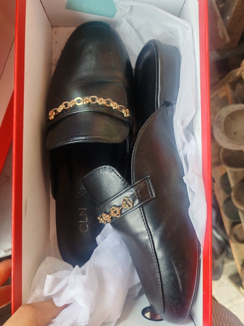 CLN Sabine Black Mules Size 38 (Category: Flats & Sandals) located in Taguig. Submitted by valentinekiwi (Listing ID 1468284593, Image 2). Description: - Brand: CLN - Style: Sabine Black Mules - Size: EU 38 - Design: Slip-on with chic gold chain link accent - Comfort: Flat heels and soft cushioned insoles - Condition: Worn only a few times, minimal creasing on upper - Inclusion: Original red shoebox included.
