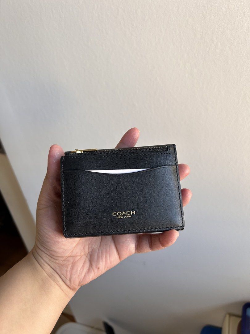 Coach Essential Card Holder Wallet (Category: Luxury Bags & Wallets) located in Quezon City. Submitted by preloved.by.gia (Listing ID 1468339063, Image 2). Description: - Authentic Coach signature canvas and smooth leather tri-fold wallet - Colorway: Dark brown and black with iconic gold-tone C hardware - Secure snap closure on the main flap - Interior features a full bill compartment and multiple card slots - Includes a detachable zip card case 
