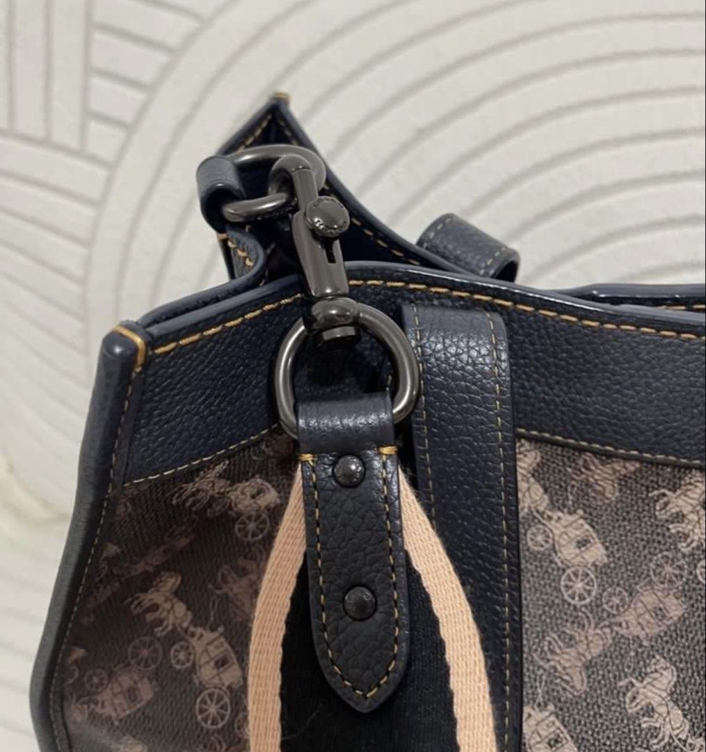 Coach Tote Bag with Strap (Category: Luxury Bags & Wallets) located in Pasig City. Submitted by becca1227 (Listing ID 1468334770, Image 2). Description: - Coach tote bag in brown and black horse and carriage print - Bought from Rustan's for 29k - Double top handles and a wide adjustable fabric shoulder strap - Includes matching leather hangtag - Comes with original white Coach dust bag and care booklet - price slightly negotiable - Mode of Paymen