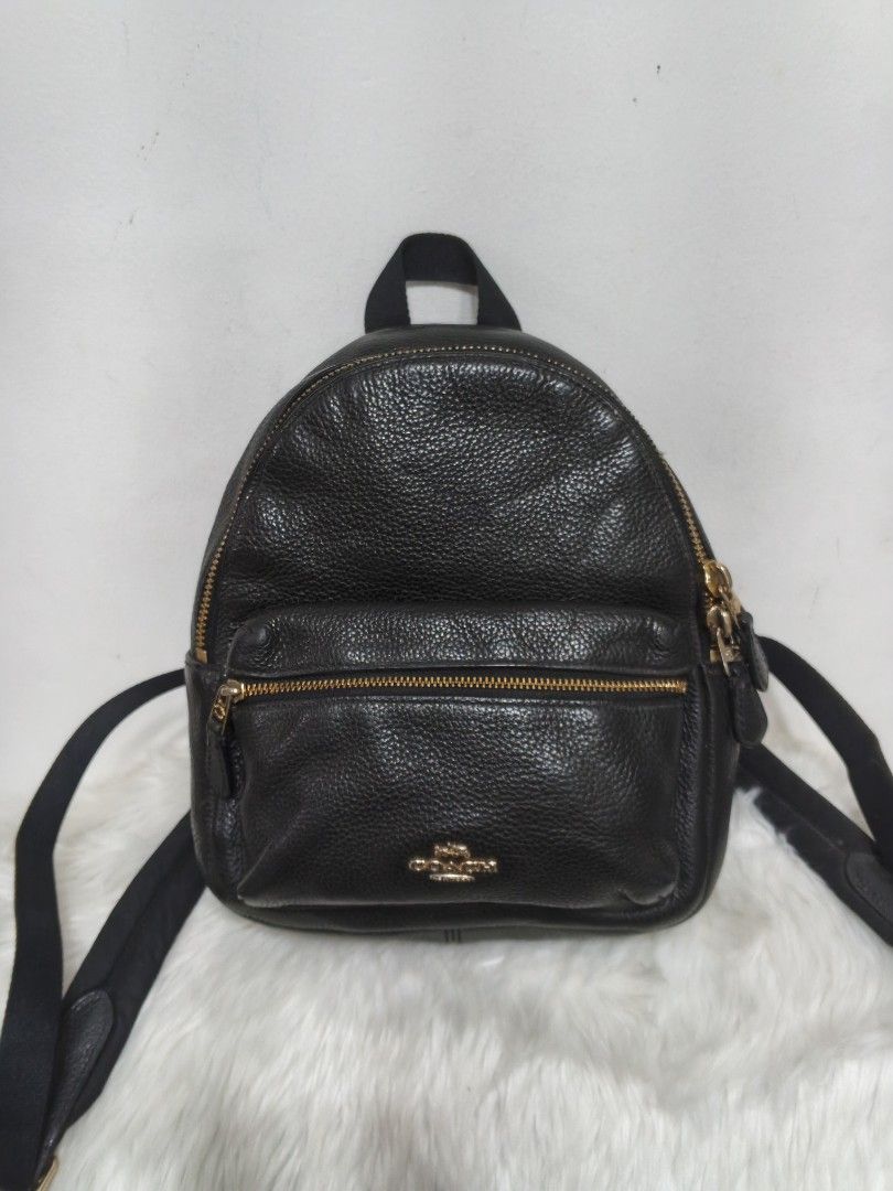 Coach Mini Charlie Backpack (Category: Backpacks) located in Malolos. Submitted by urban_thrift_09 (Listing ID 1468467524, Image 1). Description: Coach Mini Charlie Backpack featuring gold-tone hardware and a front zip pocket. Size & details please see photos..