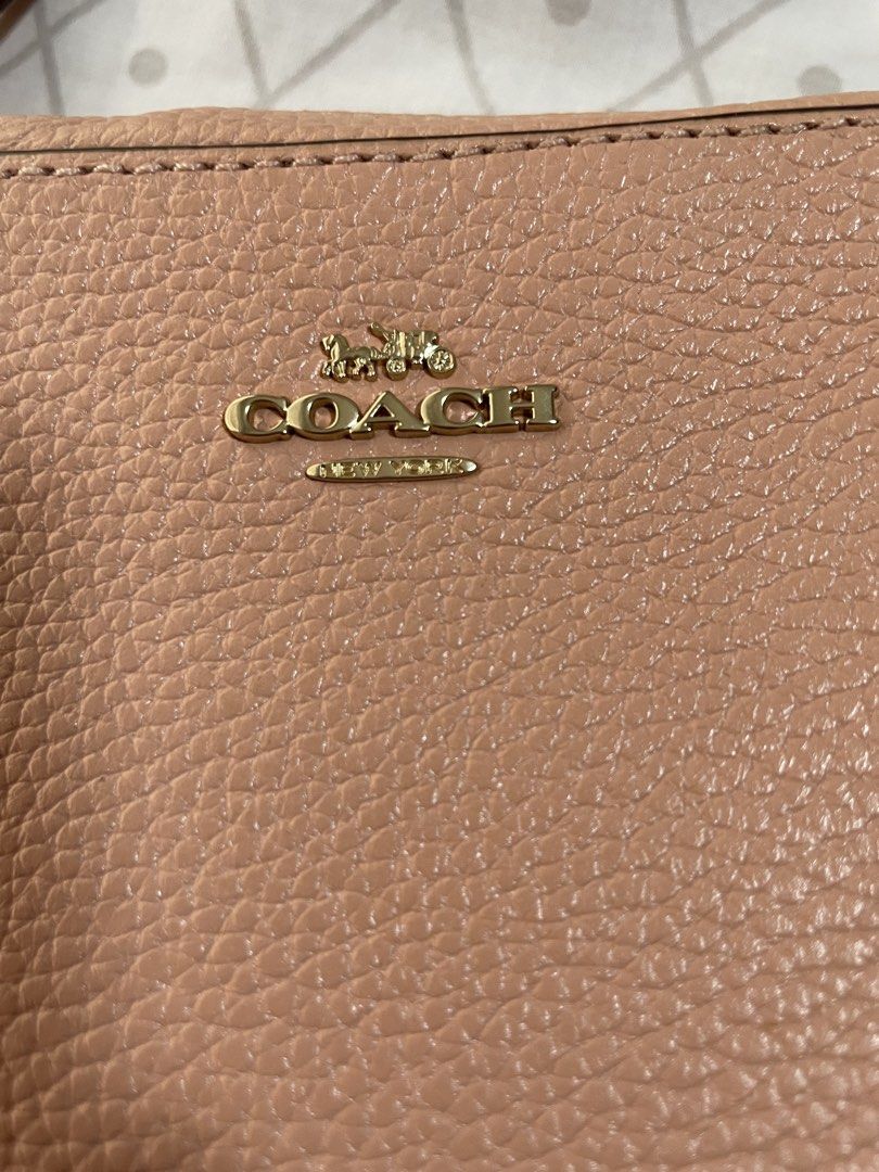 Coach Pebbled Leather Camera Bag Shell Pink 87734 (Category: Luxury Bags & Wallets) located in Quezon City. Submitted by tor_ash (Listing ID 1468321335, Image 3). Description: - Brand: Coach - Style: Pebbled leather camera bag - Color: Shell Pink with gold-tone hardware - Features: Zip top closure, exterior slip pocket, adjustable crossbody strap - Condition: like new.