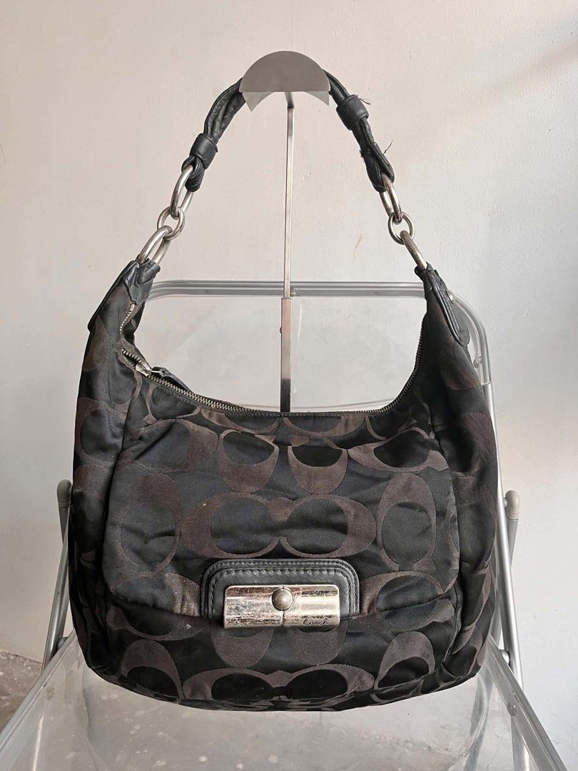 Coach Signature C Black Shoulder Bag (Category: Shoulder Bags) located in Manila. Submitted by prettyyybagss (Listing ID 1468387394, Image 1). Description: - Brand: Coach - Style: Signature C shoulder bag - Color: Black with blue interior lining - Hardware & Closure: Front flap closure, YKK zippers - Straps: Combination chain and leather strap - Pockets: Interior zipper pocket and slip pockets - Condition Notes: Visible stains and discoloration o