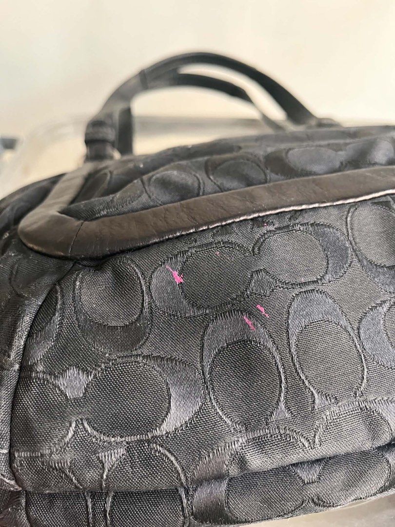 Coach Signature C Black Shoulder Bag (Category: Luxury Bags & Wallets) located in Manila. Submitted by prettyyybagss (Listing ID 1468387383, Image 2). Description: - Brand: Coach - Style: Shoulder bag / Carryall - Material: Black monogram jacquard fabric with leather trim - Hardware: Silver-tone with twist-lock front pocket - Interior: Multiple compartments with center zip section and satin lining - Condition: Minor pink stain spots on front fabr