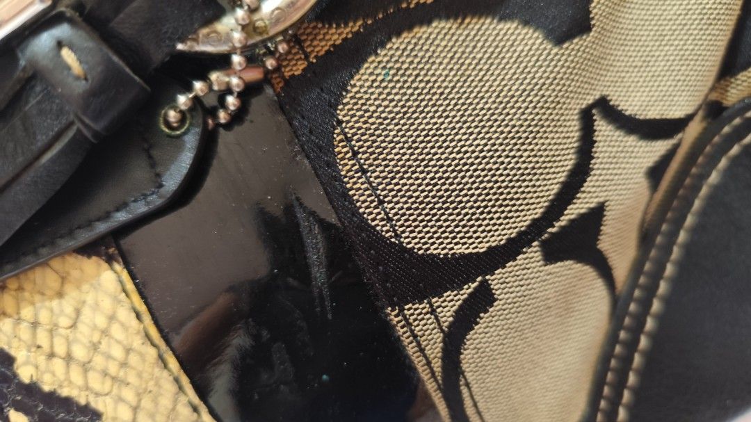 Coach Signature C Op Art Python Mixed Leather Satchel (Category: Luxury Bags & Wallets) located in Malungon. Submitted by 2ndhandoriginals (Listing ID 1468295318, Image 3). Description: - Brand: Coach - Material: Signature C canvas with black leather trim, snakeskin panel, and patent leather stripe - Accents: Tassel charm, dual top handles, zip-top closure - Inclusions: Brown dust bag included - Condition: Shows minor glue discoloration near hard