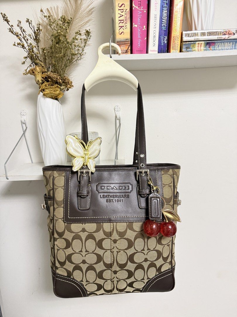 Coach Signature C Tote Bag (Category: Luxury Bags & Wallets) located in Muntinlupa City. Submitted by li.priv (Listing ID 1468424559, Image 1). Description: - Authentic Coach brown tote bag with signature monogram canvas -Fits ipad and 13” laptop - Dark brown leather trim with front embossed logo and contrast stitching - Dual shoulder straps featuring adjustable buckle hardware - Spacious and stylish for daily use or work/ school -Slightly nego! 