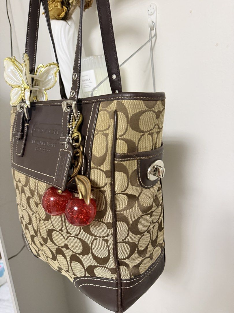 Coach Signature C Tote Bag (Category: Luxury Bags & Wallets) located in Muntinlupa City. Submitted by li.priv (Listing ID 1468424559, Image 3). Description: - Authentic Coach brown tote bag with signature monogram canvas -Fits ipad and 13” laptop - Dark brown leather trim with front embossed logo and contrast stitching - Dual shoulder straps featuring adjustable buckle hardware - Spacious and stylish for daily use or work/ school -Slightly nego! 