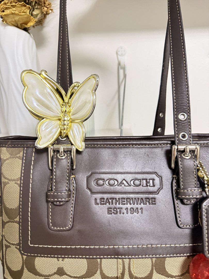 Coach Signature C Tote Bag (Category: Luxury Bags & Wallets) located in Muntinlupa City. Submitted by li.priv (Listing ID 1468424559, Image 2). Description: - Authentic Coach brown tote bag with signature monogram canvas -Fits ipad and 13” laptop - Dark brown leather trim with front embossed logo and contrast stitching - Dual shoulder straps featuring adjustable buckle hardware - Spacious and stylish for daily use or work/ school -Slightly nego! 
