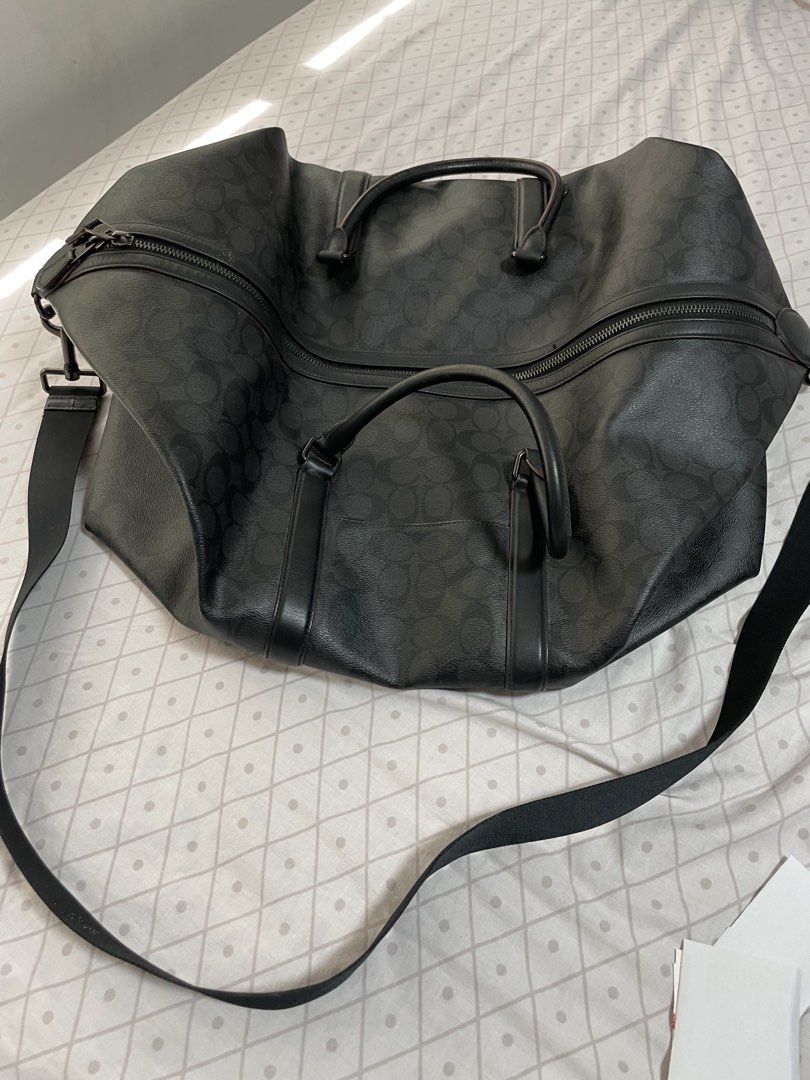 Coach Signature Canvas Black Travel Duffel Bag (Category: Luxury Bags & Wallets) located in Quezon City. Submitted by tor_ash (Listing ID 1468320708, Image 3). Description: - Authentic Coach travel duffel bag in classic black signature coated canvas - Spacious main compartment with sturdy zipper closure for easy packing - Elegant dark leather trim details throughout - Dual top handles and a convenient adjustable black shoulder strap - Ideal size 
