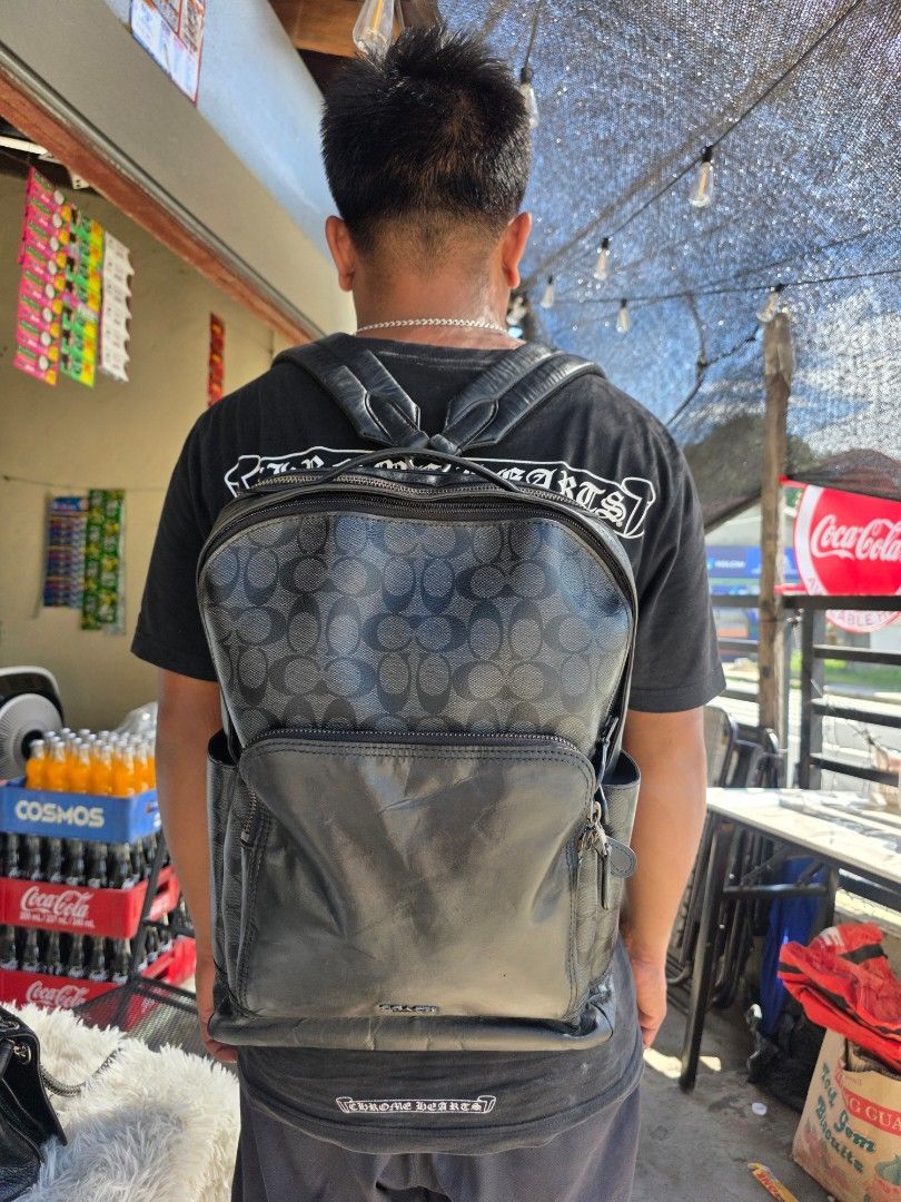 Coach Signature Leather Backpack F33755 (Category: Backpacks) located in Lemery. Submitted by venus23 (Listing ID 1468302882, Image 1). Description: - Coach backpack in classic black leather and signature monogram canvas - Spacious main compartment with a clean interior lining - Convenient front zip pocket for easy access to essentials - Comfortable mesh back padding for all-day wear - Durable leather shoulder straps with sturdy, high-quality har