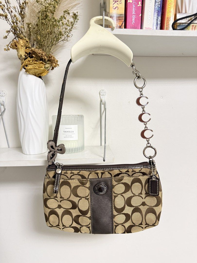 Coach Signature Mini Kili (Category: Luxury Bags & Wallets) located in Muntinlupa City. Submitted by carry.ligaya (Listing ID 1468455793, Image 1). Description: * Issues on handle and dirt at the back. No rubs on canvas. 7.5/10 ~All charms, designs and extenders are not included. ~Fits promax. Note before claiming: All sales are final. No cancellations, exchanges, returns, or refunds (including lay aways). Kindly double-check all item details bef