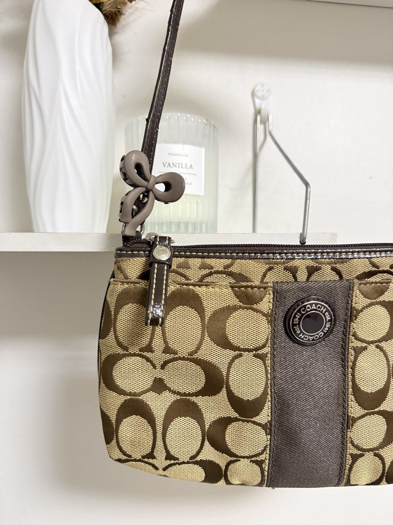 Coach Signature Mini Kili (Category: Luxury Bags & Wallets) located in Muntinlupa City. Submitted by carry.ligaya (Listing ID 1468455793, Image 3). Description: * Issues on handle and dirt at the back. No rubs on canvas. 7.5/10 ~All charms, designs and extenders are not included. ~Fits promax. Note before claiming: All sales are final. No cancellations, exchanges, returns, or refunds (including lay aways). Kindly double-check all item details bef