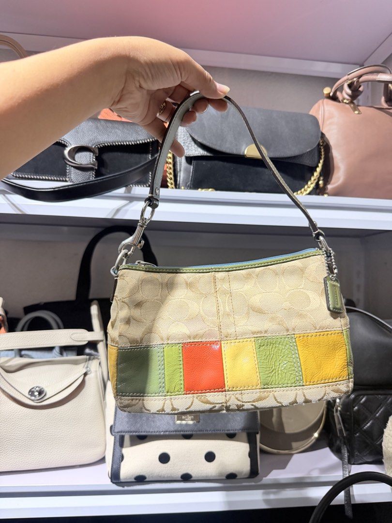 Coach Signature Patchwork Shoulder Bag (Category: Luxury Bags & Wallets) located in Taguig. Submitted by xylasprelovedbag (Listing ID 1468305613, Image 1). Description: - Authentic Coach shoulder bag in classic signature C canvas - Eye-catching multicolored leather bottom panel in green, orange, and yellow - Comfortable single leather strap secured with polished silver hardware - Secure top zip closure accented with stylish blue fabric trim - Inc