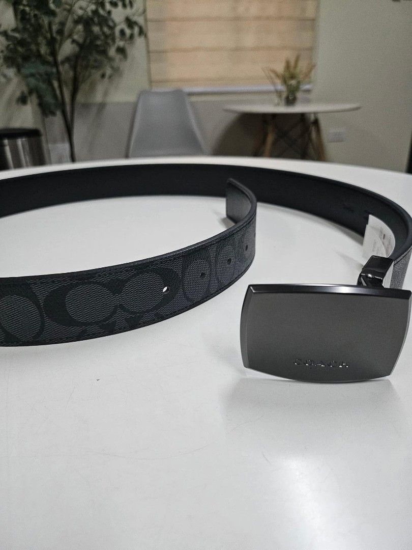 Coach Signature Reversible Belt with Interchangeable Buckles (Category: Belts) located in Pasig City. Submitted by loveeine (Listing ID 1468331877, Image 1). Description: - Brand: Coach - Design: Signature canvas in black/charcoal grey, reversible to solid black - Buckles: Includes 2 interchangeable buckles (modern plaque buckle and classic pin buckle) - Condition: Brand new with tags attached - Packaging: Comes in the original Coach gift box - 1