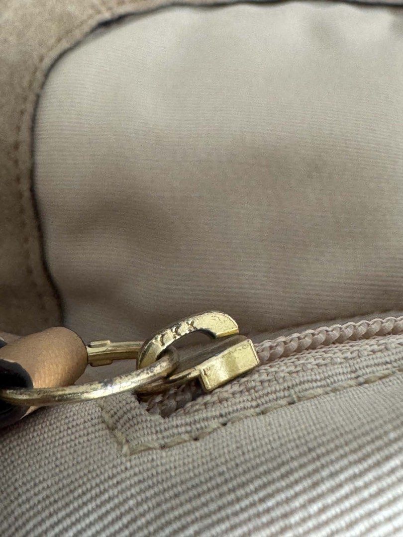 Coach Suede Shoulder Bag (Category: Shoulder Bags) located in Manila. Submitted by prettyyybagss (Listing ID 1468385308, Image 3). Description: - Authentic Coach shoulder bag in classic tan suede - Features a bold front buckle closure with brass hardware - Sturdy shoulder strap with secure ring connectors - Fabric-lined interior with a convenient zipper pocket - Includes serial number stamped on the interior leather patch - Condition note: Shows 