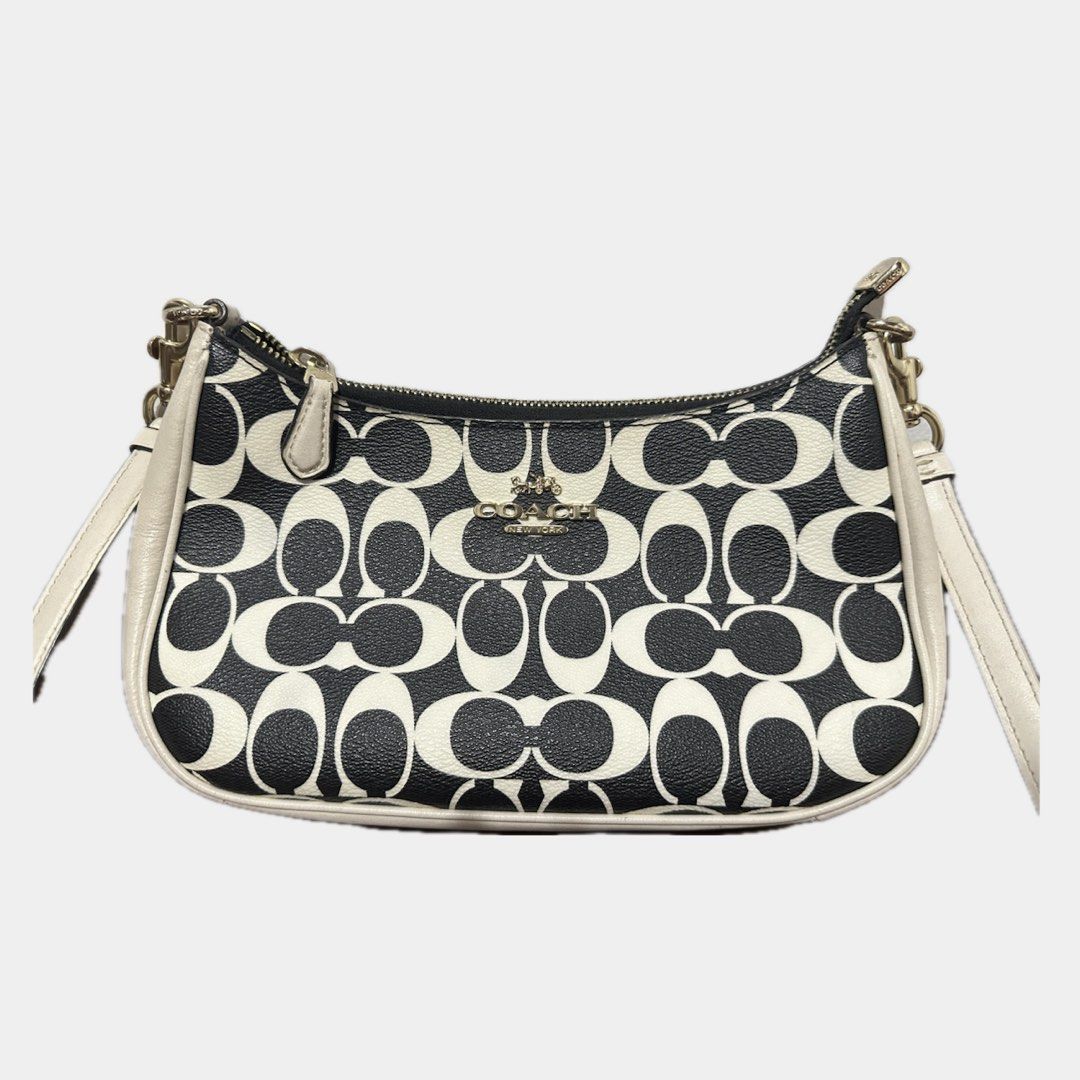 Coach teri shoulder bag (Category: Cross-body Bags) located in Paranaque City. Submitted by annvzsn (Listing ID 1468498699, Image 1). Description: Color: white/black Size: 9.5" (L) x 6.0" (H) x 3.0" (W) Material: smooth leather Bought in: US (physical store) Condition: heavily used Details: - Designed for everyday use - Coated canvas with smooth leather - Adjustable long strap ♡ It doesn’t come with a short handle strap because I lost it, bought 