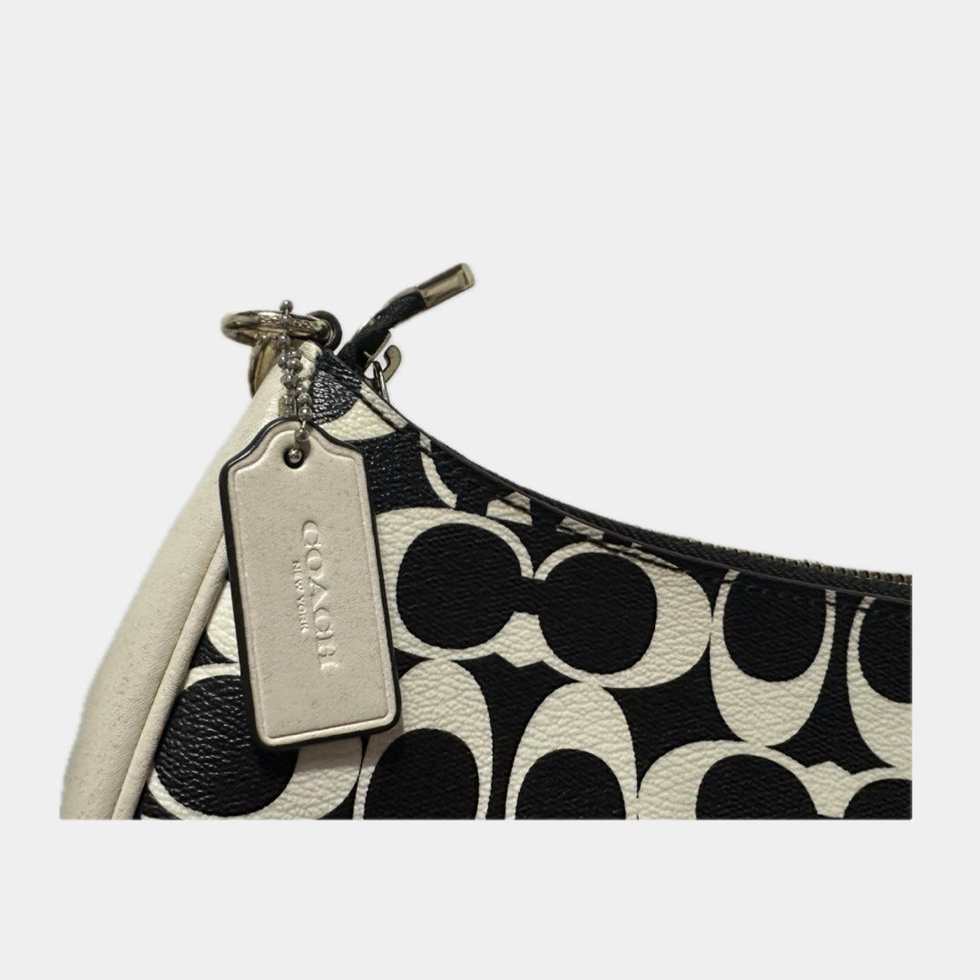 Coach teri shoulder bag (Category: Cross-body Bags) located in Paranaque City. Submitted by annvzsn (Listing ID 1468498699, Image 3). Description: Color: white/black Size: 9.5" (L) x 6.0" (H) x 3.0" (W) Material: smooth leather Bought in: US (physical store) Condition: heavily used Details: - Designed for everyday use - Coated canvas with smooth leather - Adjustable long strap ♡ It doesn’t come with a short handle strap because I lost it, bought 