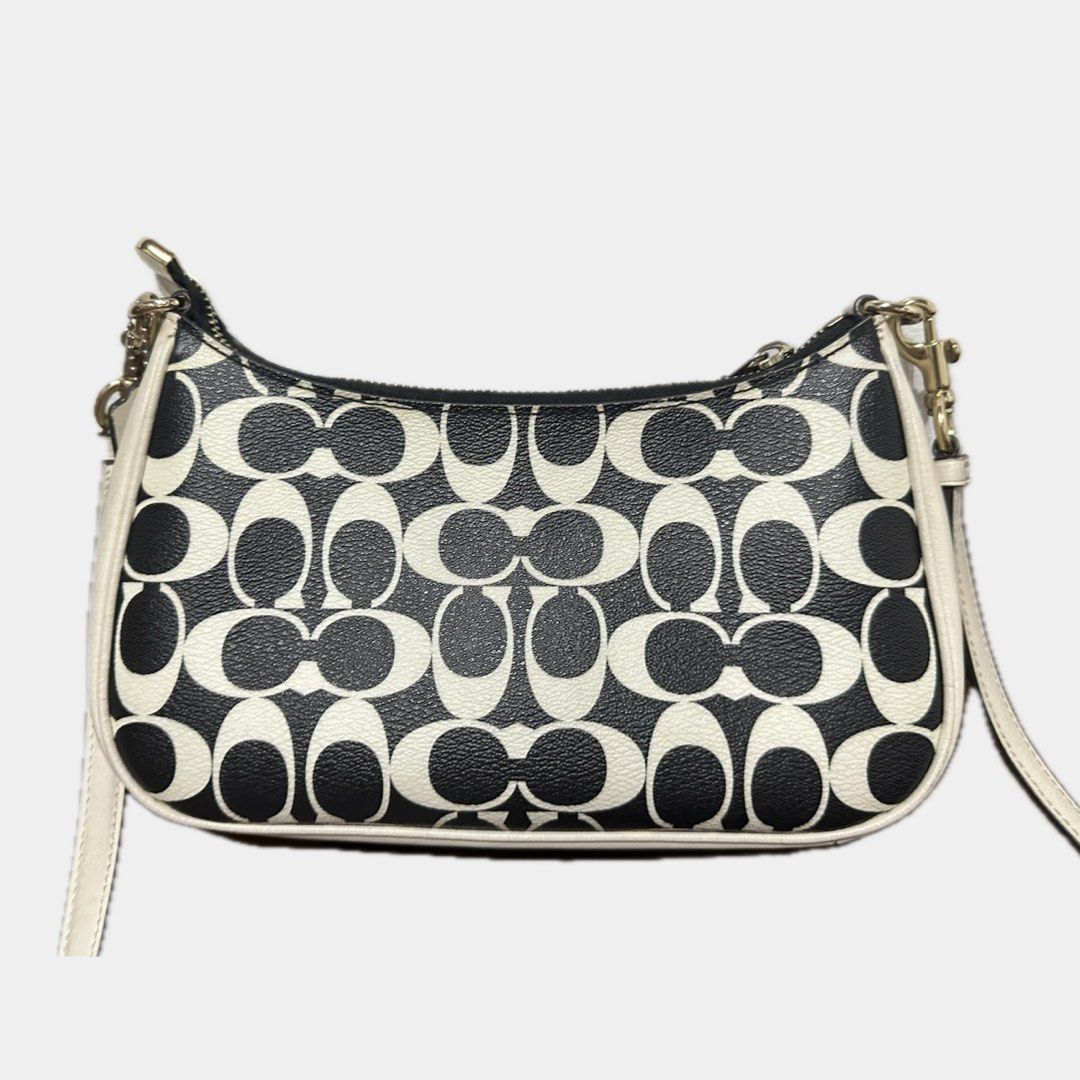 Coach teri shoulder bag (Category: Cross-body Bags) located in Paranaque City. Submitted by annvzsn (Listing ID 1468498699, Image 2). Description: Color: white/black Size: 9.5" (L) x 6.0" (H) x 3.0" (W) Material: smooth leather Bought in: US (physical store) Condition: heavily used Details: - Designed for everyday use - Coated canvas with smooth leather - Adjustable long strap ♡ It doesn’t come with a short handle strap because I lost it, bought 