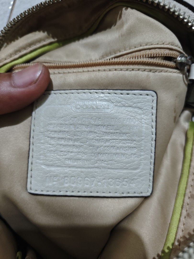 Coach White Leather Shoulder Bag (Category: Luxury Bags & Wallets) located in Isulan. Submitted by jaysthrift (Listing ID 1468296231, Image 2). Description: - Brand: Coach - Material: White pebbled leather with silver-tone hardware - Features: Buckle strap detail, zip-top closure, and beige fabric lining - Storage: Interior zippered pocket and creed patch with serial number (B0967-13654) - Inclusions: Original Coach hangtag and decorative charm -