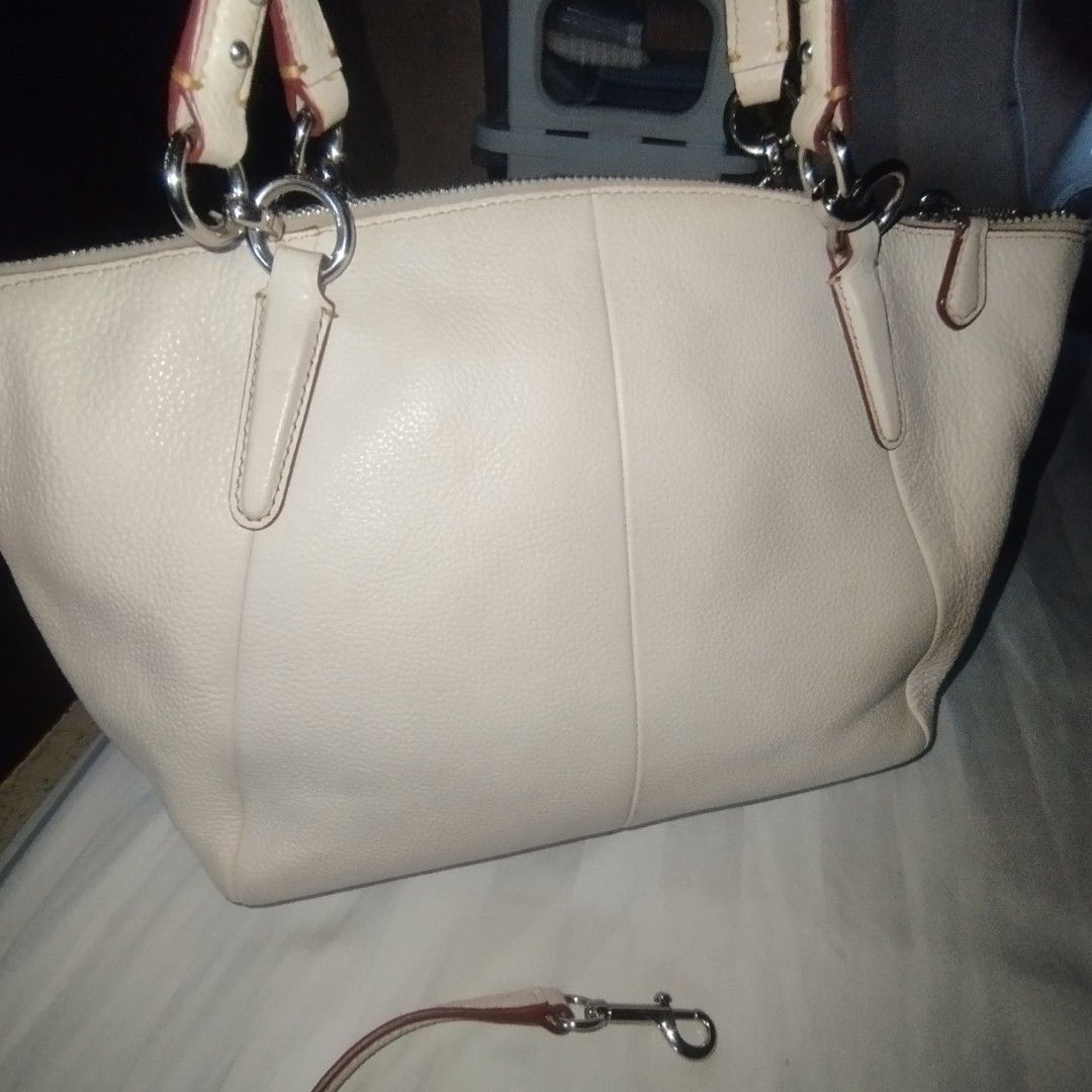 Coach White Leather Studded Satchel Handbag (Category: Cross-body Bags) located in Manila. Submitted by lene48 (Listing ID 1468392241, Image 3). Description: - Brand: Coach - Style: Leather Satchel / Shoulder Bag - Color: Off-white with silver hardware - Details: Metal stud accents on the lower front and stamped Coach logo - Interior: Brown fabric lining with slip pockets and one zip pocket - Straps: Twin carry handles and a detachable shoulder s