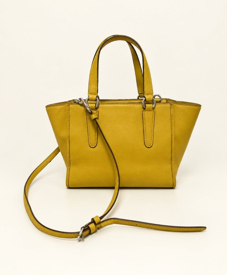 Coach 2way bag in yellow (Category: Luxury Bags & Wallets) located in Lucena. Submitted by amirahsoonlineshop (Listing ID 1468485711, Image 2). Description: - Hardware: Silver-tone with signature hangtag - Handles/Strap: Double top handles and a detachable shoulder strap - Closure: Secure zippered top - lightly used.