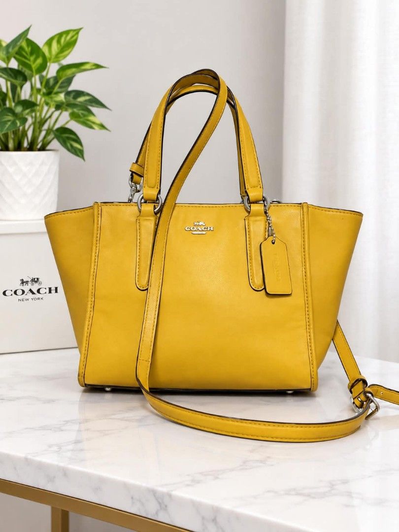 Coach 2way bag in yellow (Category: Luxury Bags & Wallets) located in Lucena. Submitted by amirahsoonlineshop (Listing ID 1468485711, Image 1). Description: - Hardware: Silver-tone with signature hangtag - Handles/Strap: Double top handles and a detachable shoulder strap - Closure: Secure zippered top - lightly used.