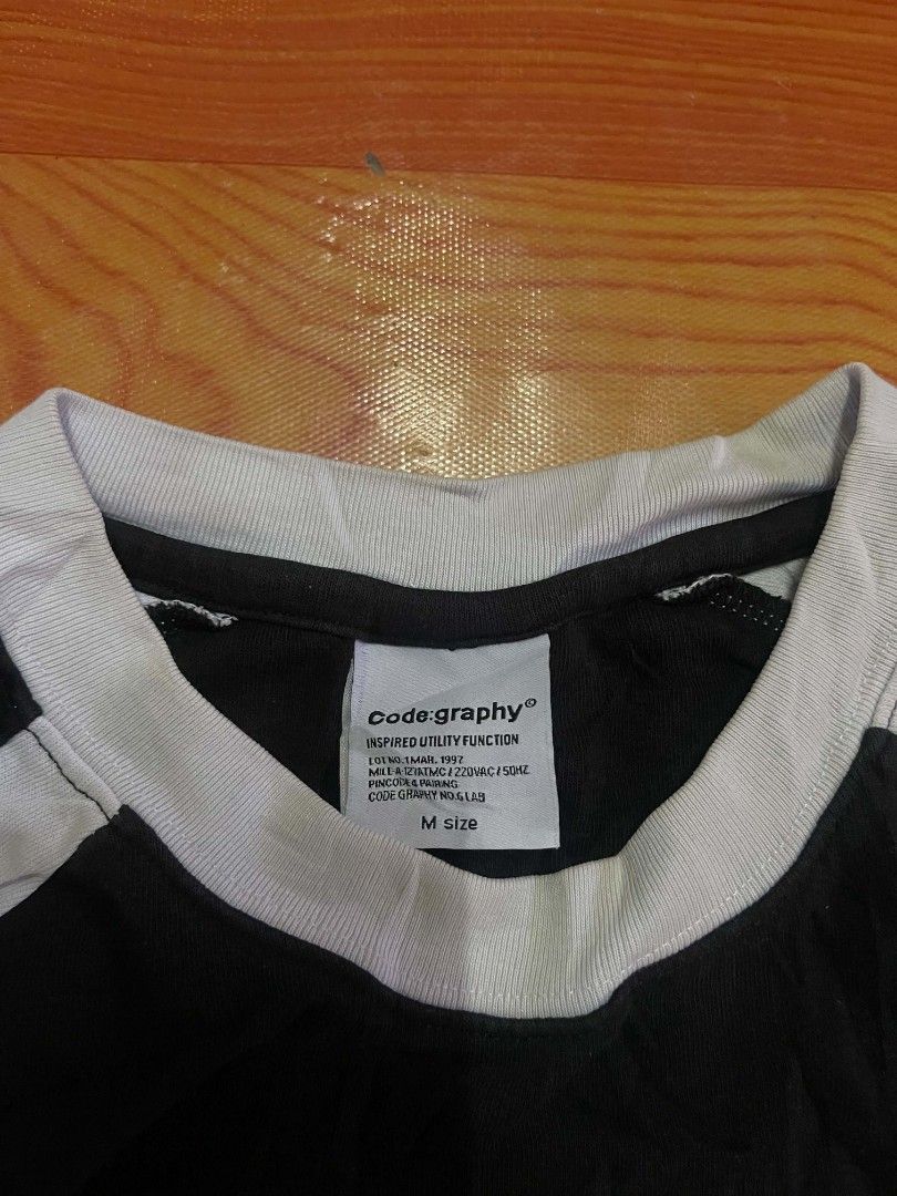 Codegraphy Worldwide Archive Graphic T-Shirt Black Size M (Category: Tshirts & Polo Shirts ) located in Ozamiz City. Submitted by tripft.vonde (Listing ID 1468311992, Image 3). Description: - Brand: Codegraphy - Color: Black with white and green panel details - Size: M (Regular fit) - Design: Large 'CODEGRAPHY WORLDWIDE ARCHIVE' front print with CGP and WORLD WIDE logos - Features: Contrast white collar and raglan-style sleeves - Authenticity: In
